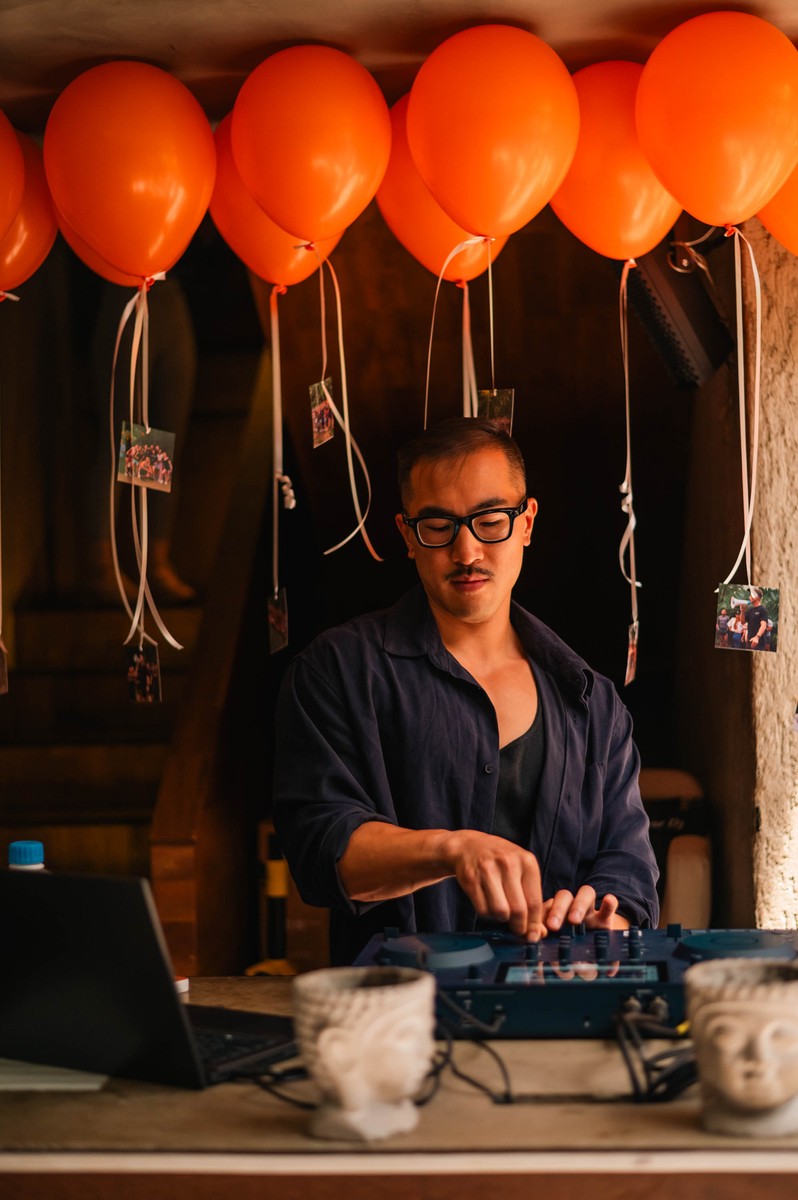 Sean Chi DJing under balloon decor at a private party