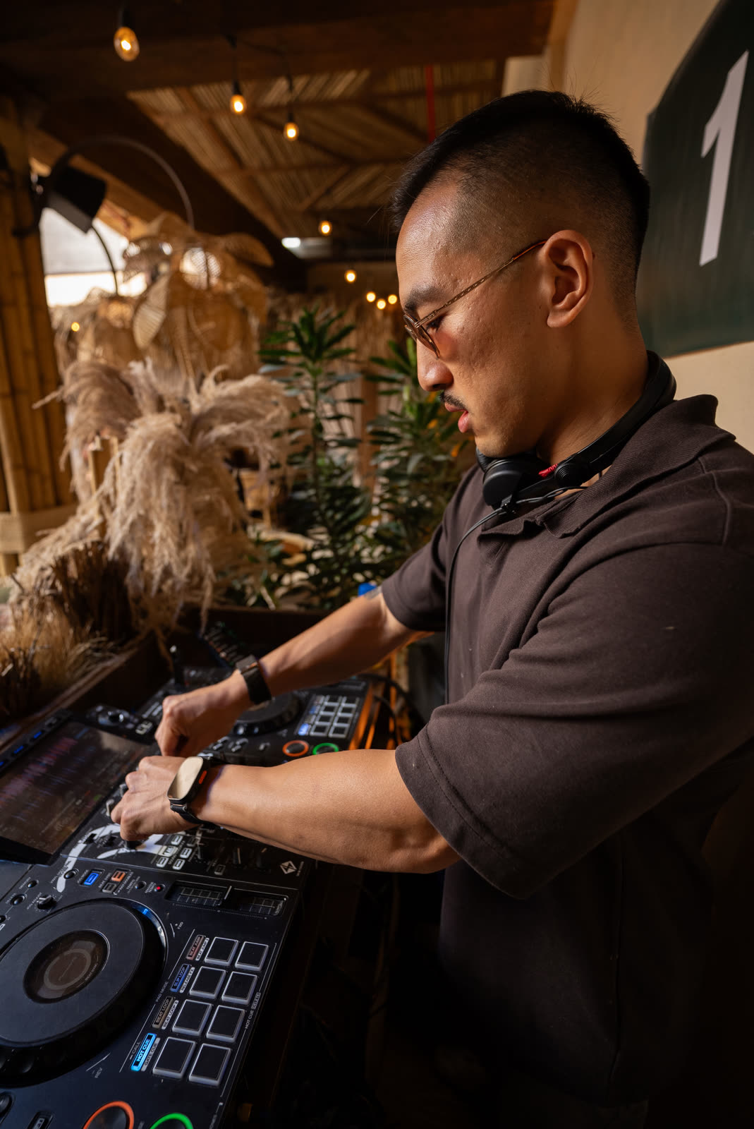 Sean Chi mixing on CDJs at a boho-styled venue