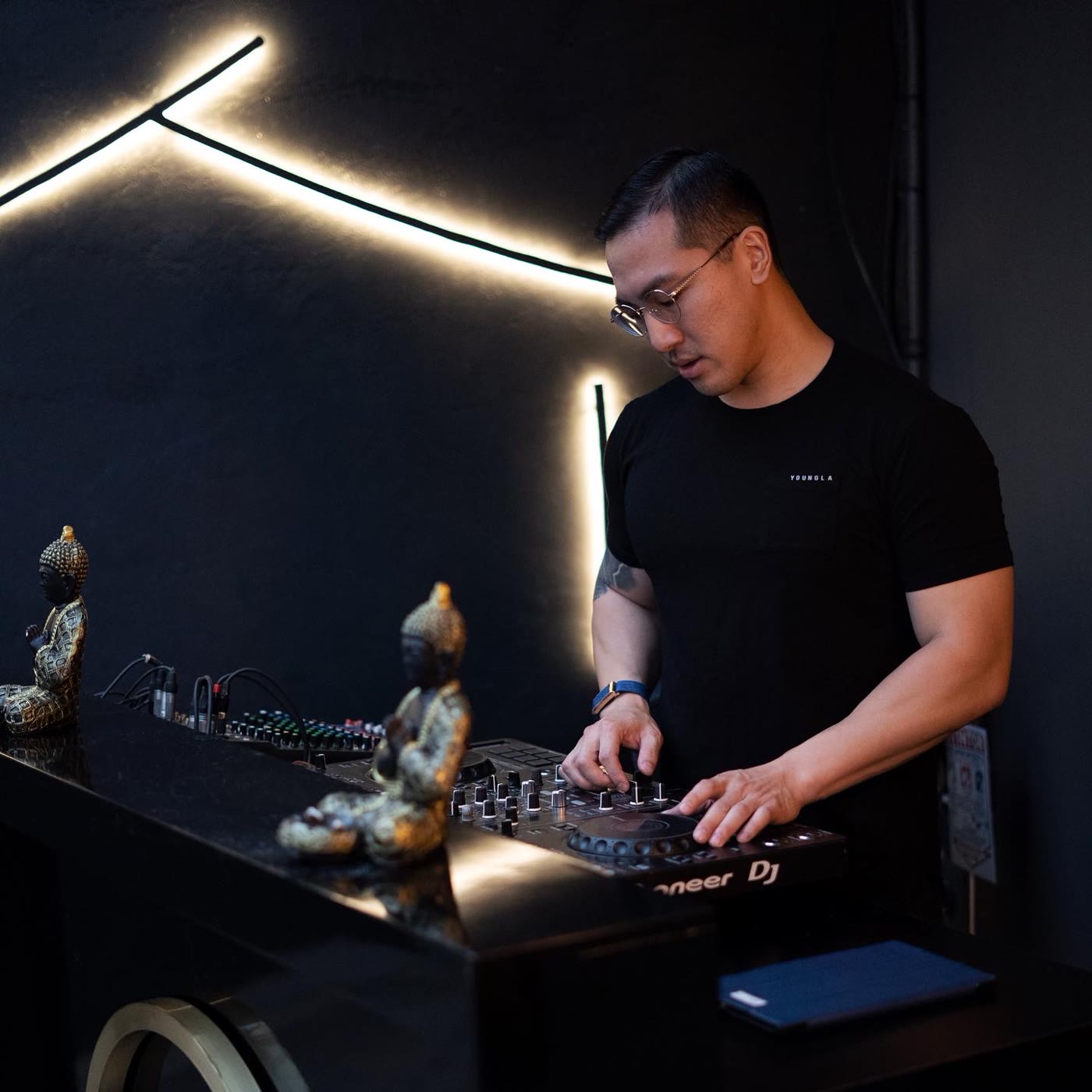 Sean Chi DJing a club room with LED lighting